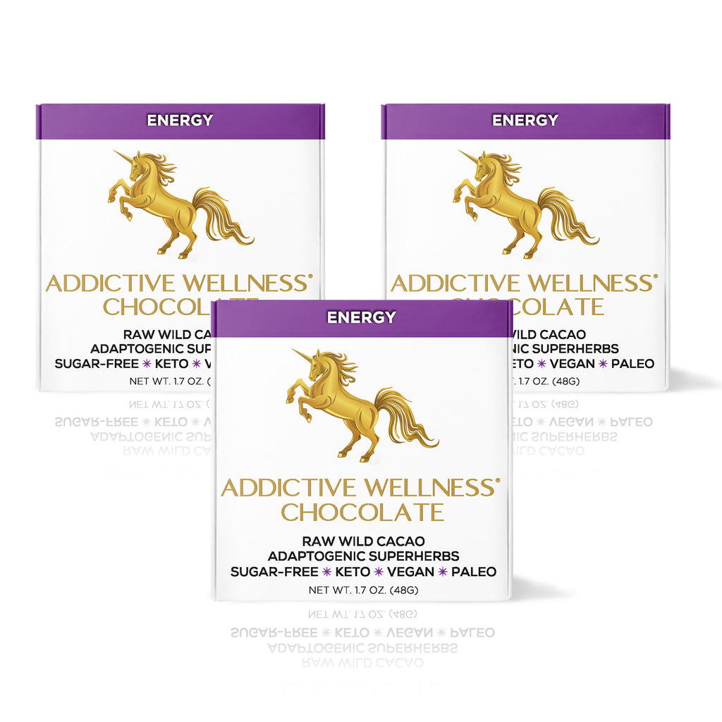 Three packages of Addictive Wellness Chocolate with a gold unicorn logo on a white background.