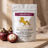 A white stand-up pouch of Addictive Wellness Mangosteen dietary supplement, styled on a stone surface with fresh mangosteen fruits in the foreground against a warm beige background.