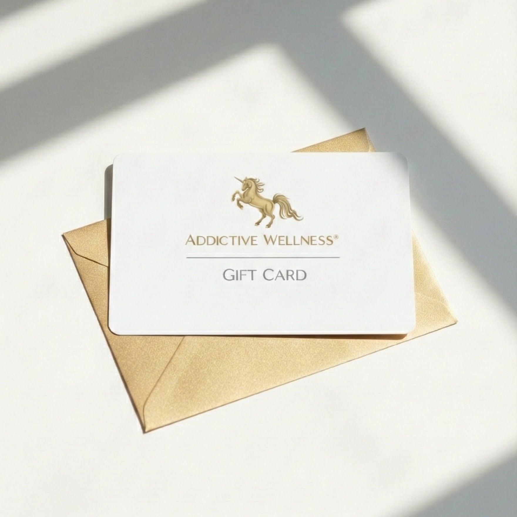 Addictive Wellness gift card with gold envelope on a light surface