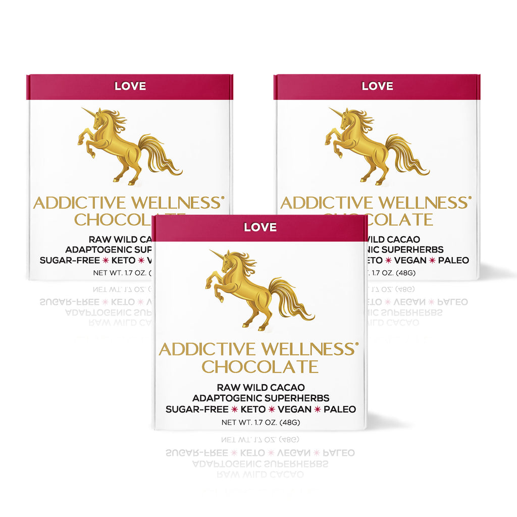Three packages of Addictive Wellness Chocolate with a unicorn logo on a white background